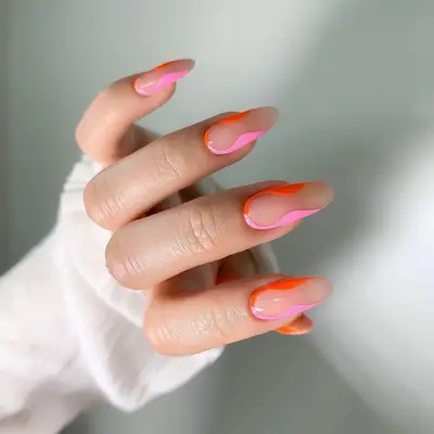 Sheer jelly almond-shaped nails with pink and orange squiggle borders - MYM Beauty Festival Nails