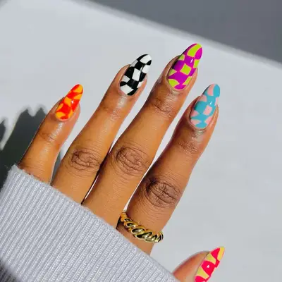 Wavy checker nail art in orange, marigold, black, white, purple, green, blush, blue, yellow, and coral - MYM Beauty Festival Nails