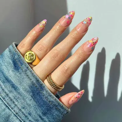 Almond-shaped nails with multicolor butterfly confetti tips - MYM Beauty Festival Nails