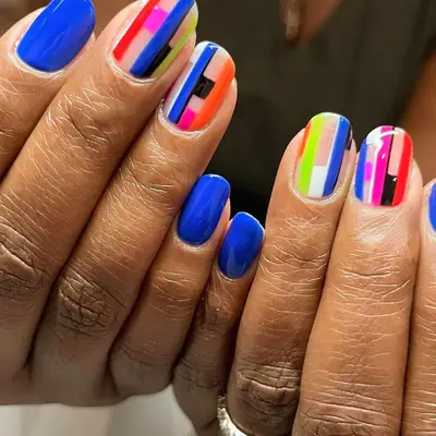 Cobalt nails with abstract multicolor stripe accents - MYM Beauty Festival Nails