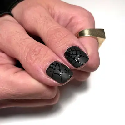 short matte black nails with glossy black webs
