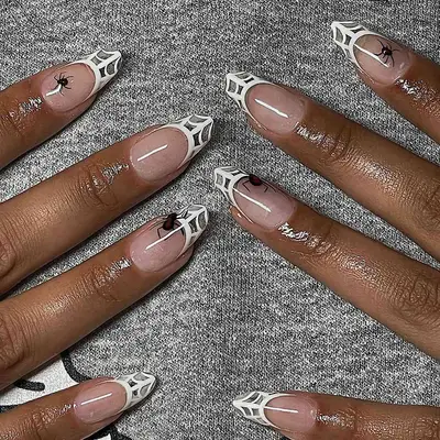 a spiderweb french manicure with hyper-realistic spiders