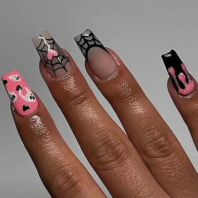 a black and pink manicure with spider web accent nails