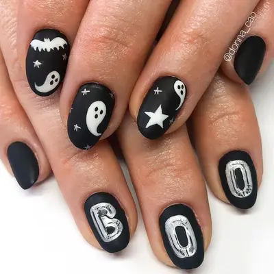 Matte black and white nails with spooky design