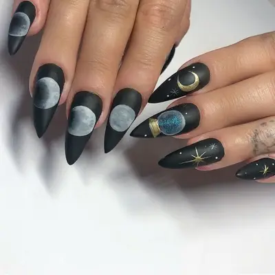 Matte black nails with celestial designs