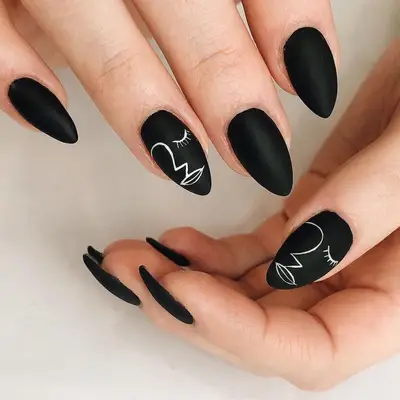 Matte black nails with face outlines