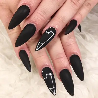 Matte black nails with Leo zodiac design