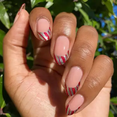 French manicure with red and silver candy cane striped tips