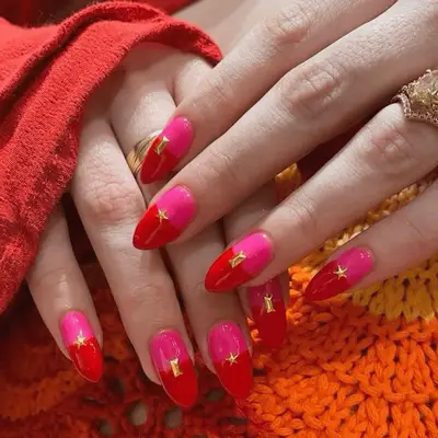 Manicure with red French tips, pearls at cuticle, and accent nails with pearls and gold shell charms