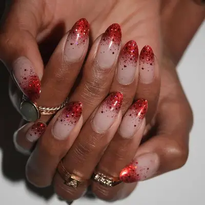 Neutral manicure with red glitter ombre tips