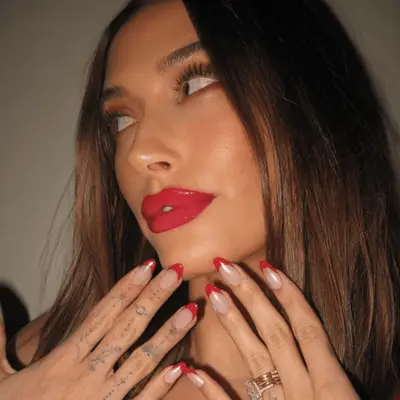 hailey bieber with a red french tip manicure