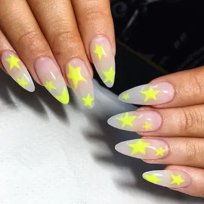 Sheer nude nails with neon yellow stars