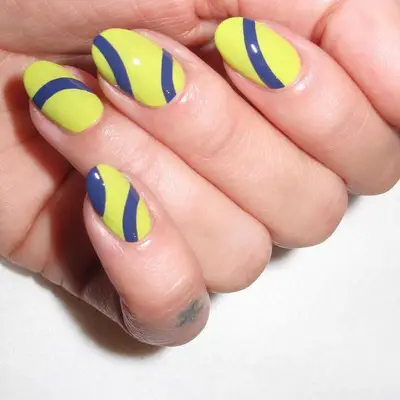 neon yellow nails with blue tennis ball design
