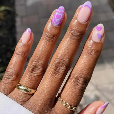 manicure with purple hearts and swirls