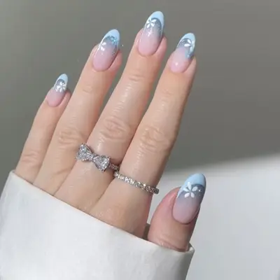 blue french manicure with glitter and flowers