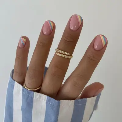 Pastel manicure with rainbow asymmetrical tips