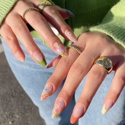 manicure with multicolored florals mixed with French manicure tips
