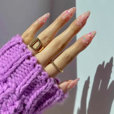 Peachy neutral lip gloss nails with colorful gems