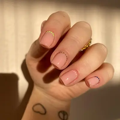 A minimalist polka dot manicure.