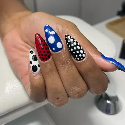 Mismatched polka dot manicure.