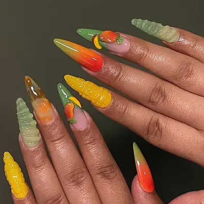 Hands with creative nail art in vegetable shapes and gradients