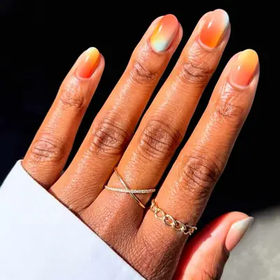 Manicured hand wearing two rings