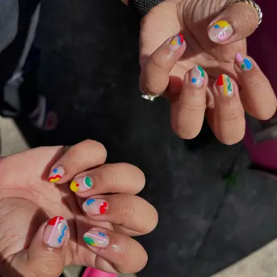 Hands with colorful abstract nail art