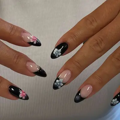 Manicured nails decorated with flower patterns on each hand