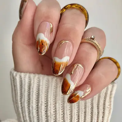 Brown, cream, and chrome gold French nails.