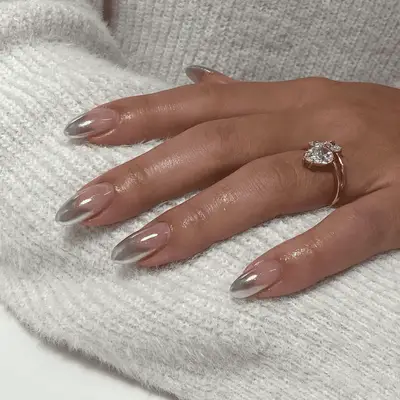 Silver chrome French tip nails with a gradual fade toward the cuticle line.