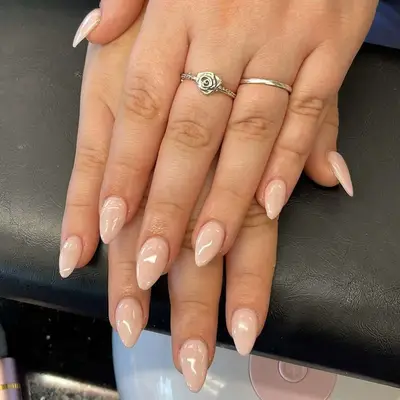 Short almond nails with shiny nude polish