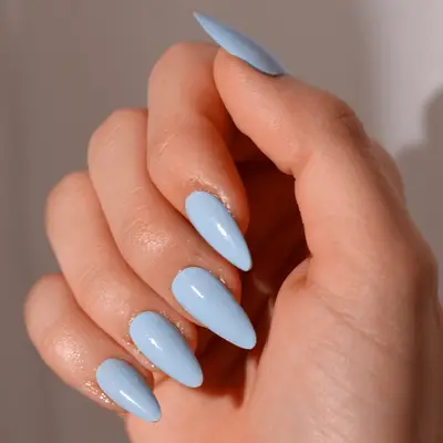 Close up of long oval nails with baby blue 
