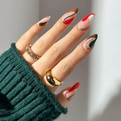 red, green, brown, and white swirly manicure