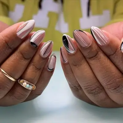 mdoel with short almond nails with white and black lines