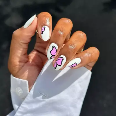 Model with white nails with bright pink butterfly design