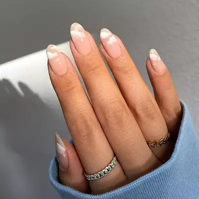model with pink nails with clouds on the tip