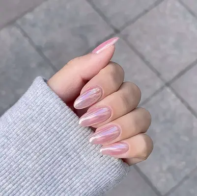 Close up of a pink chrome manicure 