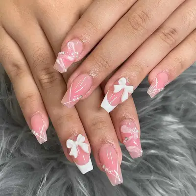 Close up of a glossy pink manicure with 3D accents