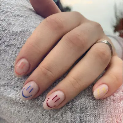 nude nails with smiley faces