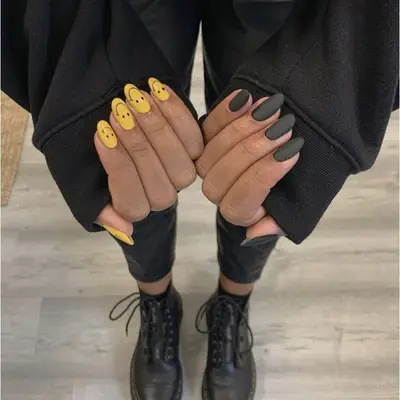 half smiley face nails half black nails