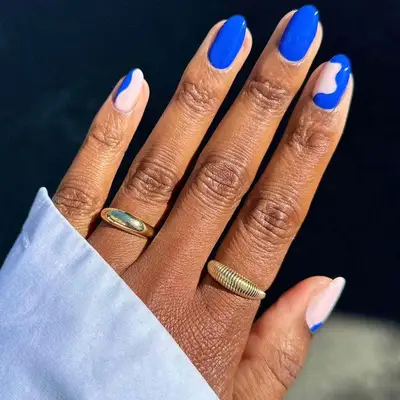 bright blue manicure with squiggle accent nails