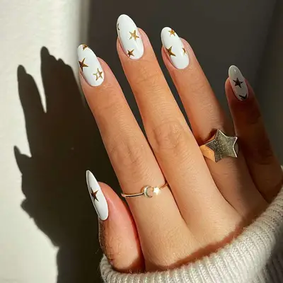 white manicure with gold star accents