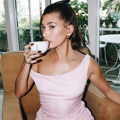 Hailey Bieber with tortoiseshell manicure sipping from teacup