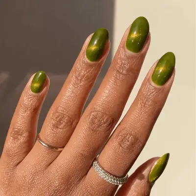 Short round nails with green galaxy design