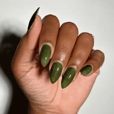 Hand folded in with with short stiletto green nails