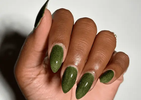 Hand folded in with with short stiletto green nails