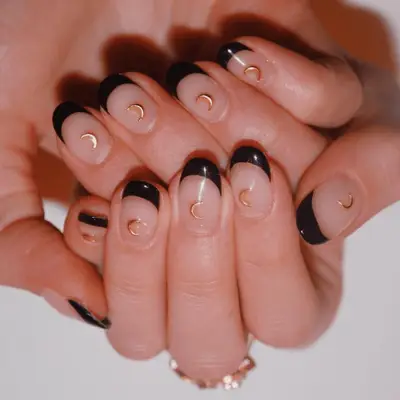 Black French manicure with gold moon nail stickers