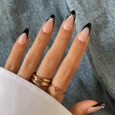 Black French manicure with pink bows