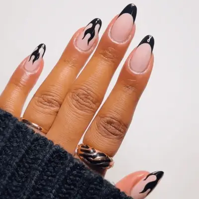 Black French manicure with flame accent nails
