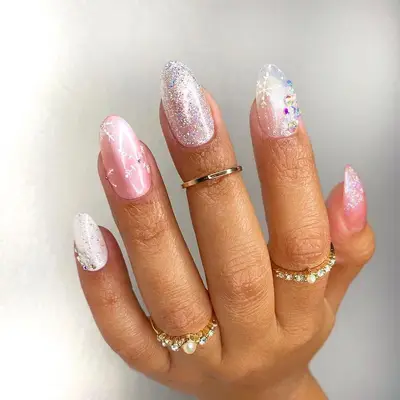 Pink and silver sparkle manicure with varied snowflake designs